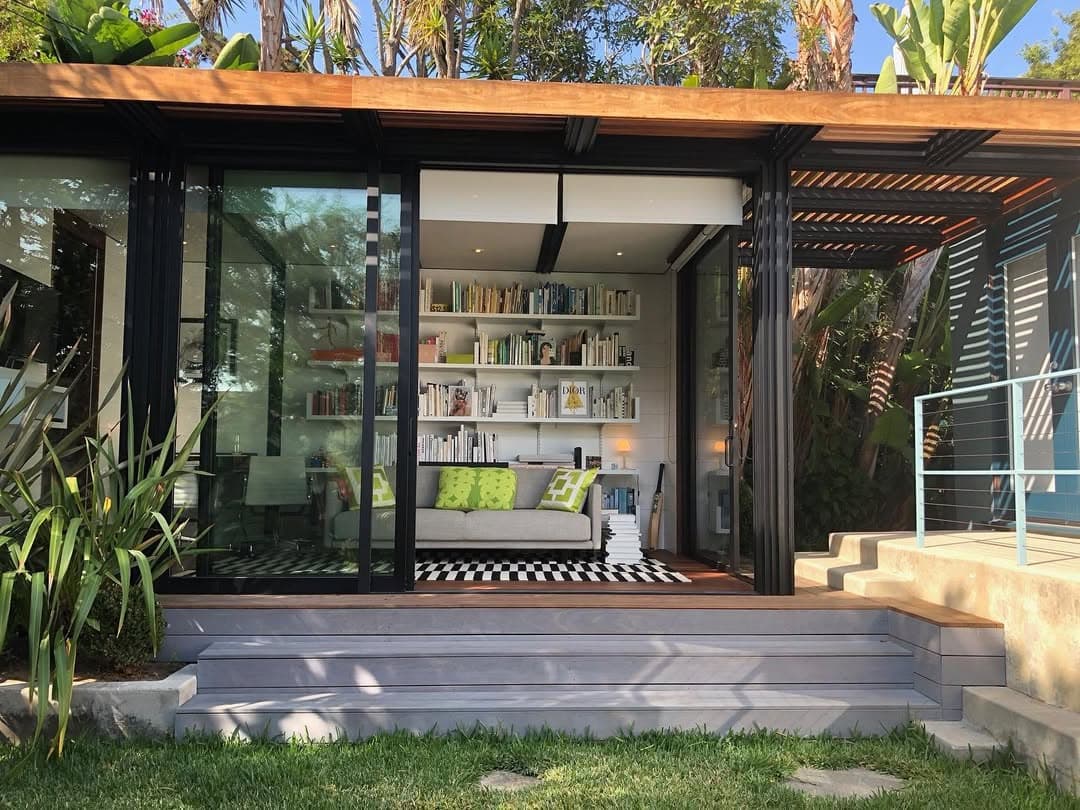 Glass-walled home office with wood cladding and pergola