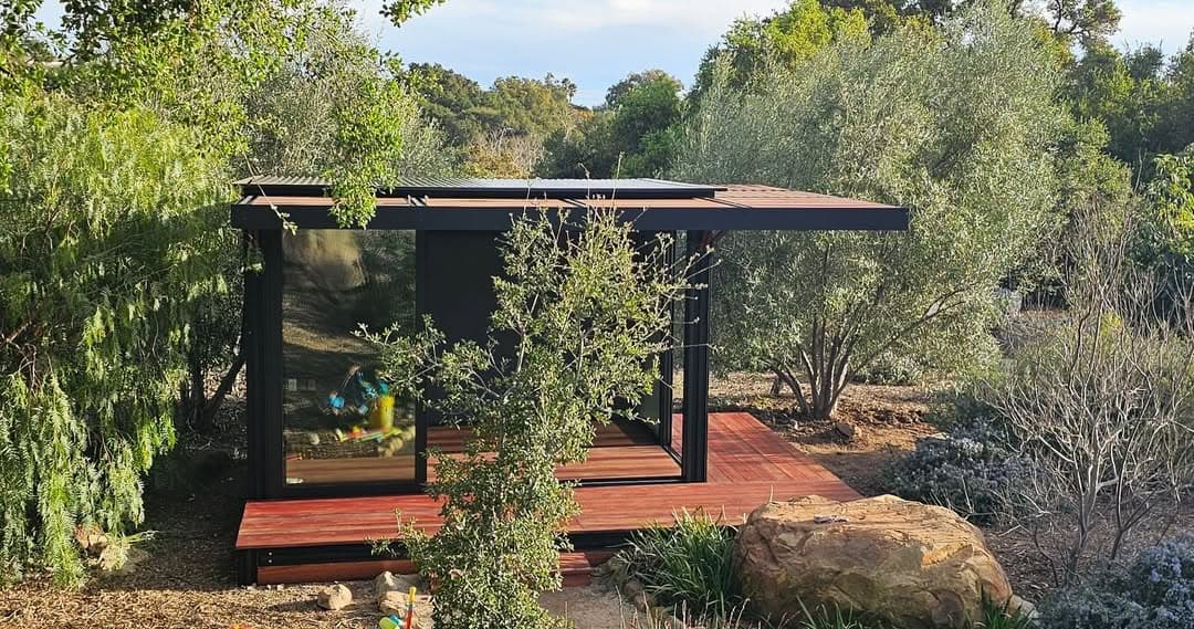 Compact structure nestled in native landscape